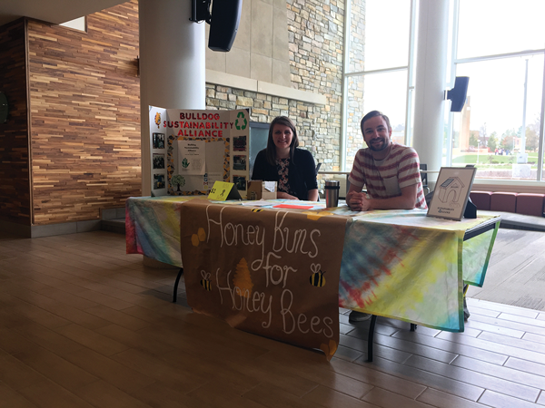 (Left) Junior in Biology–Pre-Optometry Taylor Scheurer, of Manton, Michigan, treasurer of the Bulldog Sustainability Alliance RSO, and (right) recent Environ-mental Biology grad Symon Cronk, of Newaygo, BSA president, sold treats for donations to the organization’s pollinator assistance program at the University Center on April 21.