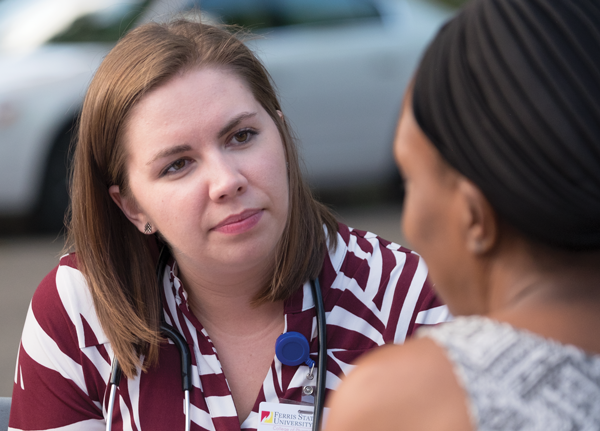 Alissa Johnson, a 2017 graduate of Ferris’ Pharmacy program, provides a health screening consultation to a participant at the CHIA event at Hillcrest Baptist Church in Grand Rapids on Aug. 31, 2016.