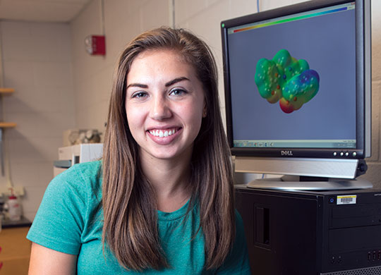 2017 Student Research Fellowship student participant Jordan Lee in front of a computer.