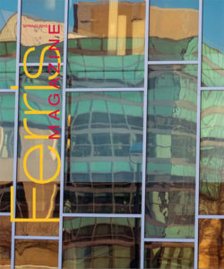 Cover of the Spring 2015 Ferris Magazine, featuring a reflected image of Ferris' FLITE building seen in the glass of adjacent University Center Window.