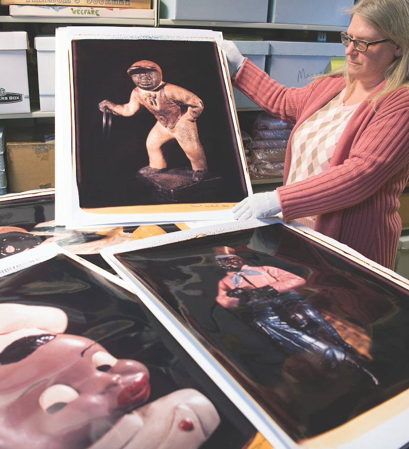 Jim Crow Museum Curator Lisa Kemmis displays large-format Polaroids from the Levinthal collection. 